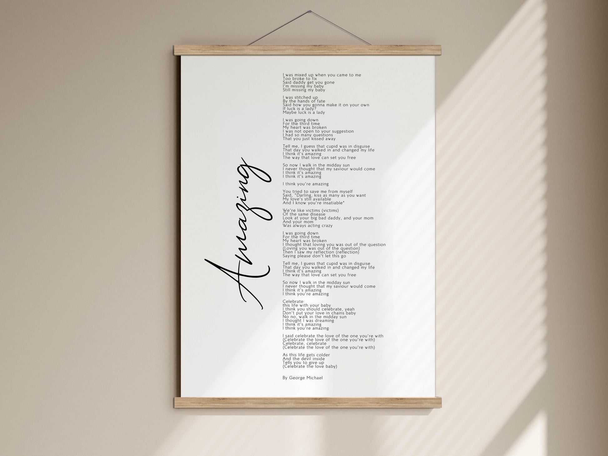 The image is a framed print of a poem titled "An Amazing" by George Michael. The poem is written in black cursive font and is displayed on a white wall.
