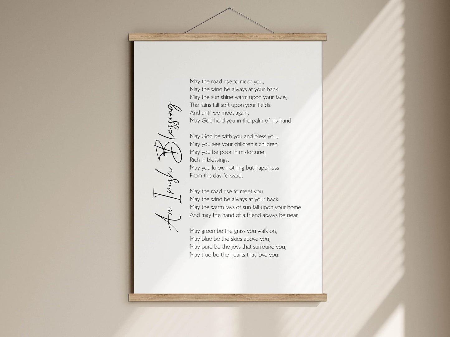 a white poster with a black cursive inscription, which appears to be a poem or a prayer. The poster is mounted on a wall and is described as a "white poster" and "white poster on a wall". The text on the poster is not described in detail, but it is a poem or a prayer with a message about meeting someone and the importance of love and friendship.