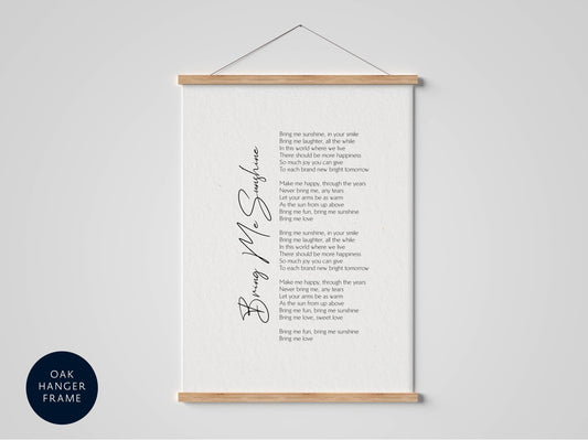 a framed poem titled "Bring Me Sunshine" with a wooden hanger frame. The poem is written in black text and is displayed on a white background.