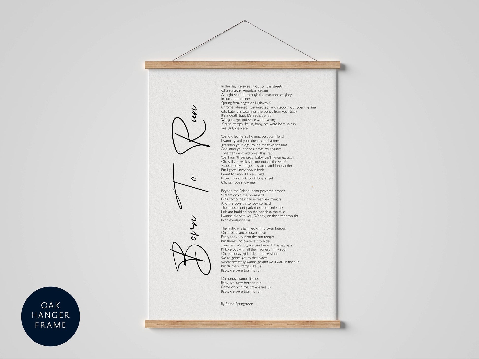 The image is a framed print of a poem titled "Born to Run" by Bruce Springsteen, which is hung on a wall.