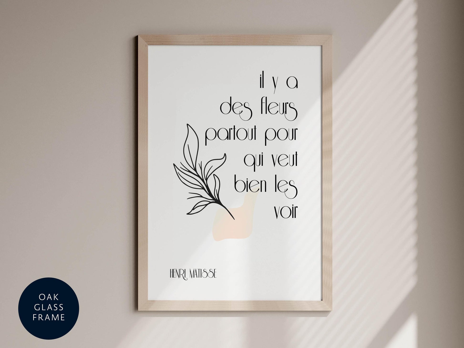 a framed poster with a quote in French, which reads "Il y a des fleurs partout pour qu'il vie tout bien les voirs" by Henri Matisse.