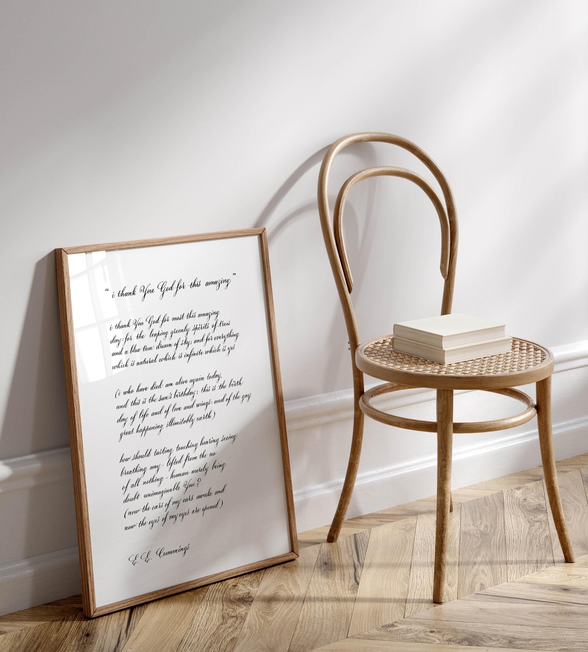 a wooden chair with a white book resting on it, positioned next to a framed handwritten message on a wall.