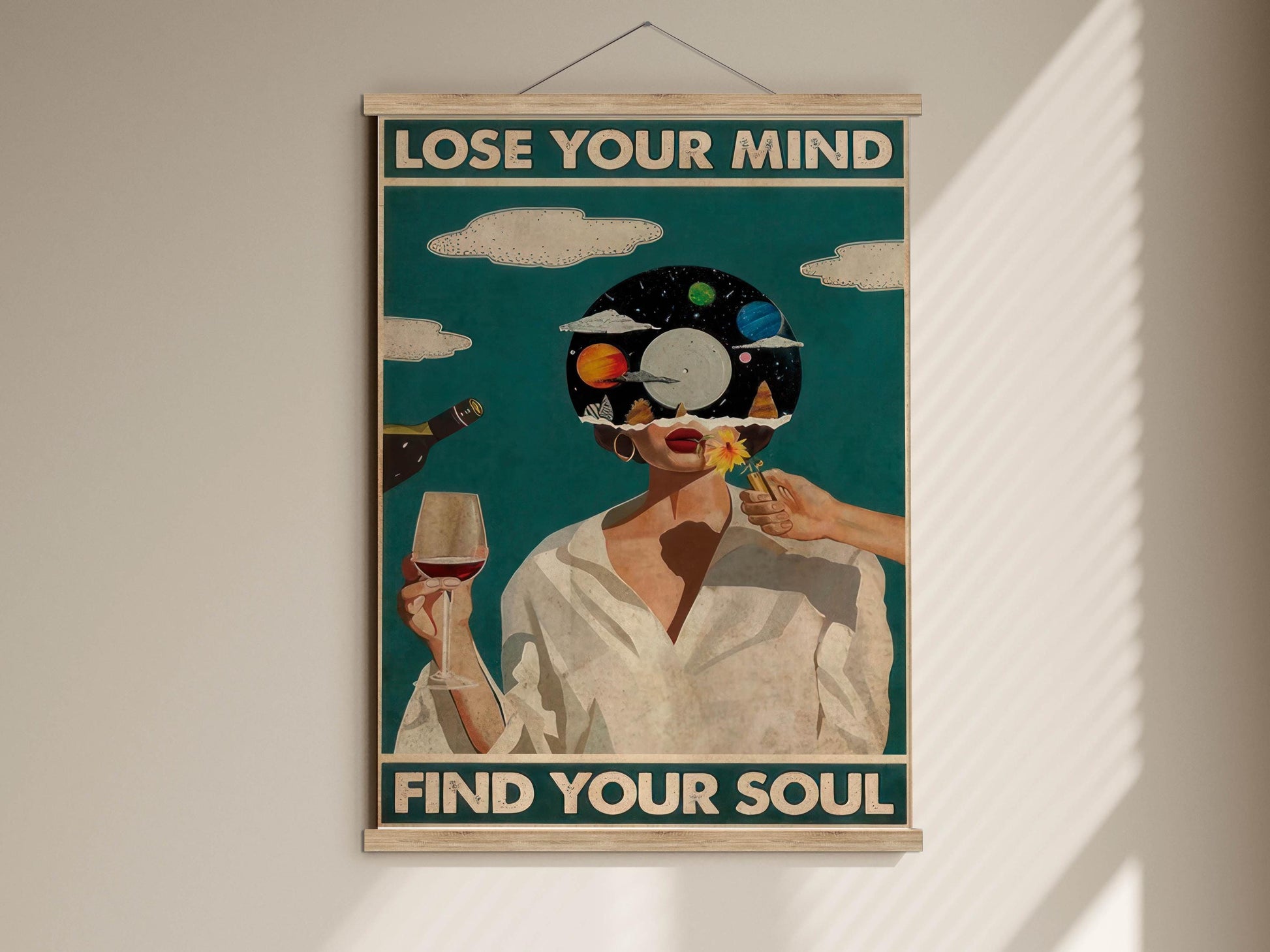 The image is a framed poster with a woman holding a wine glass and a flower, set against a backdrop of a blue sky with clouds. The text on the poster reads "LOSE YOUR MIND FIND YOUR SOUL".