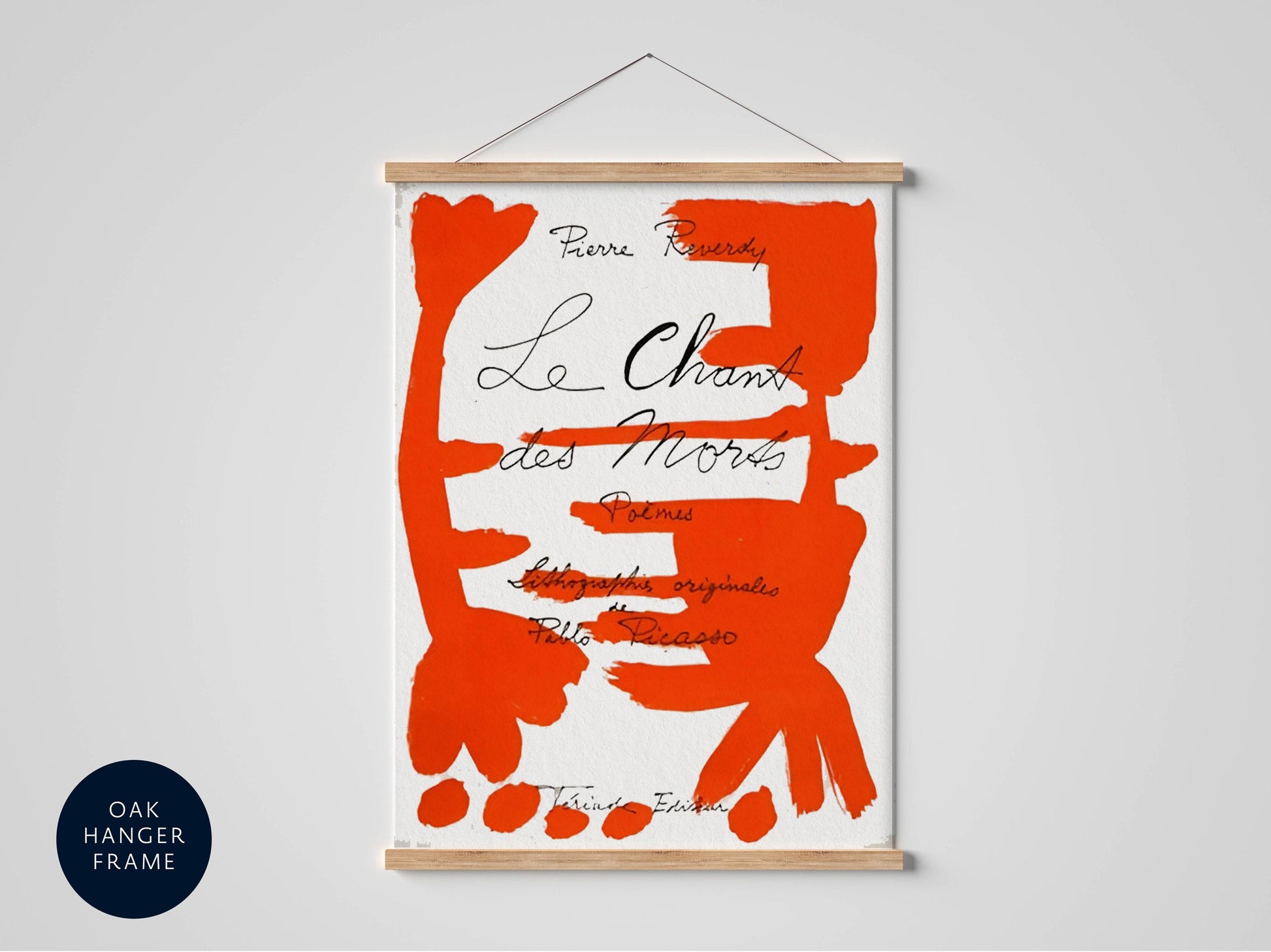 The image is a poster or artwork featuring a large, abstract red shape with black text and a wooden frame.