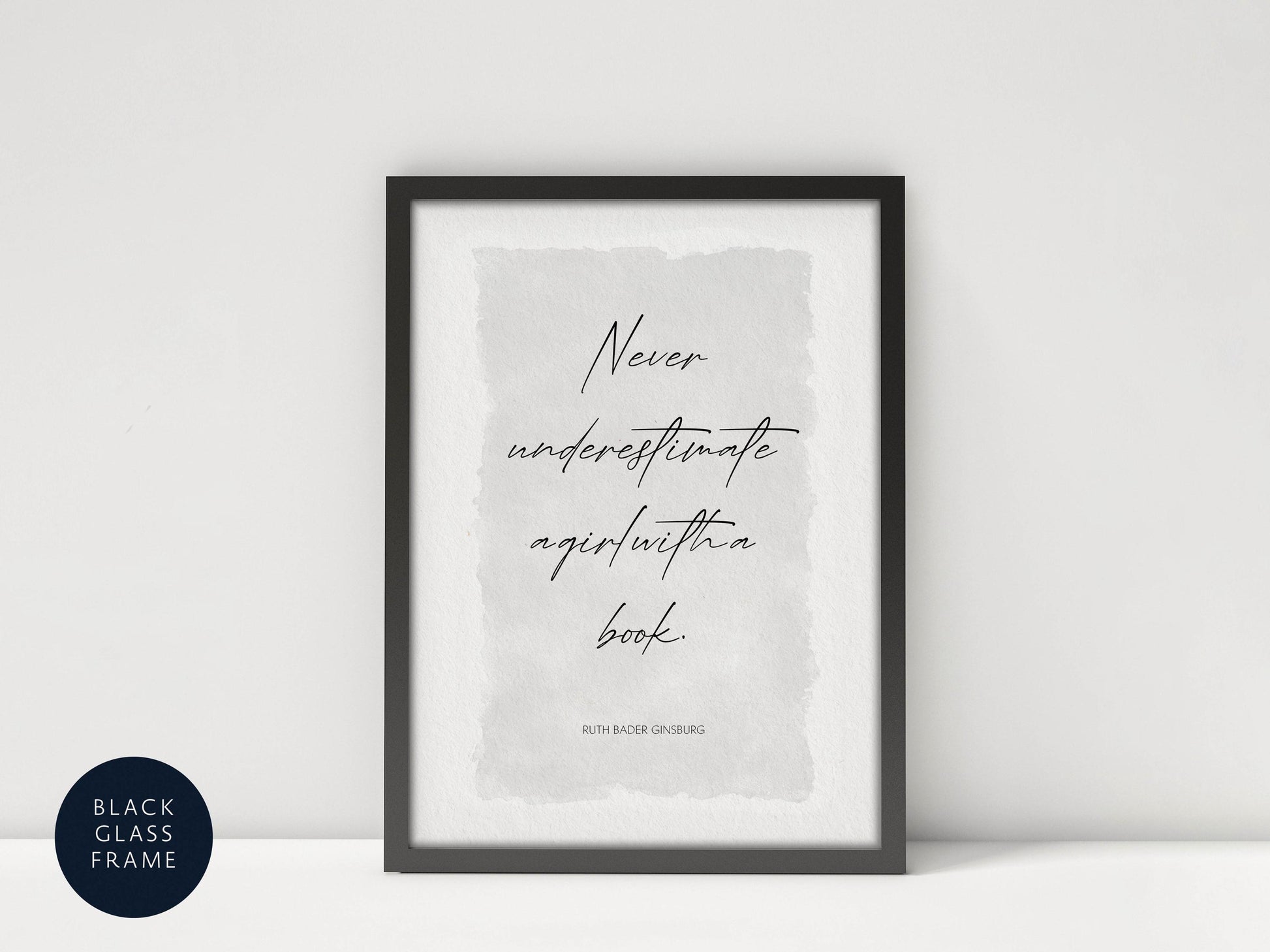 a framed quote by Ruth Bader Ginsburg, which reads "Never underestimate agirl within a book."