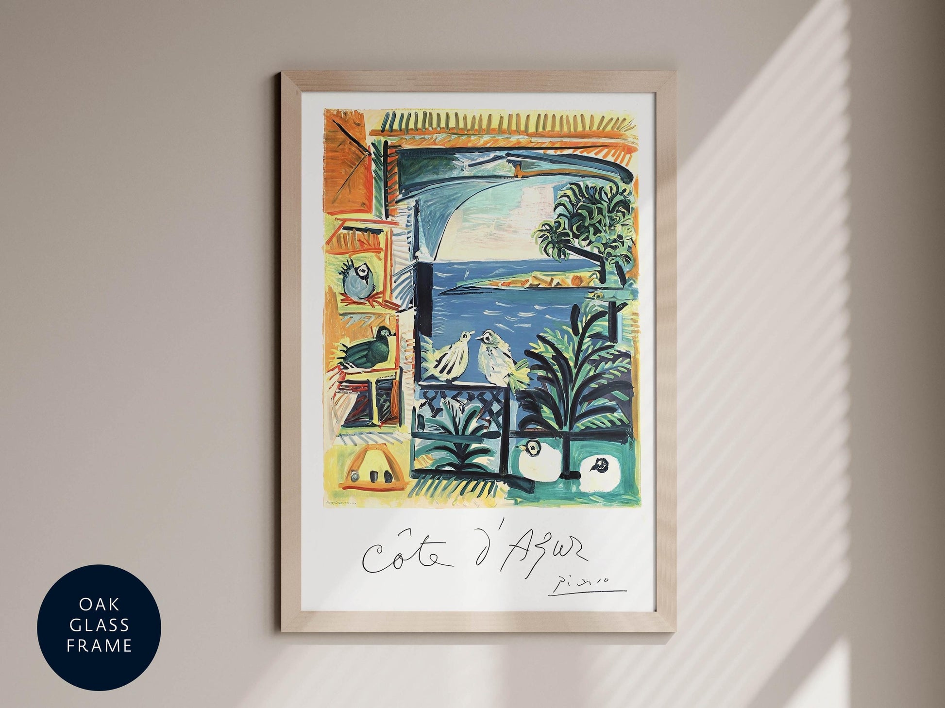 The image is a framed artwork depicting a colorful, abstract scene with various elements such as birds, palm trees, and a body of water.