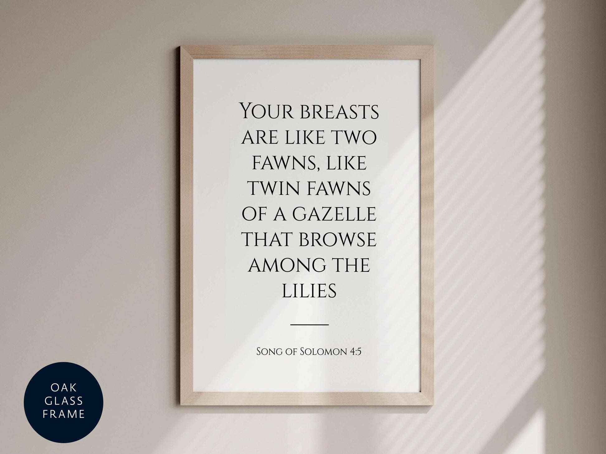 a framed quote from the song of Solomon 4:5, which reads "Your breasts are like two fawns, like twin fawns of a gazelle that browse among the lilies".