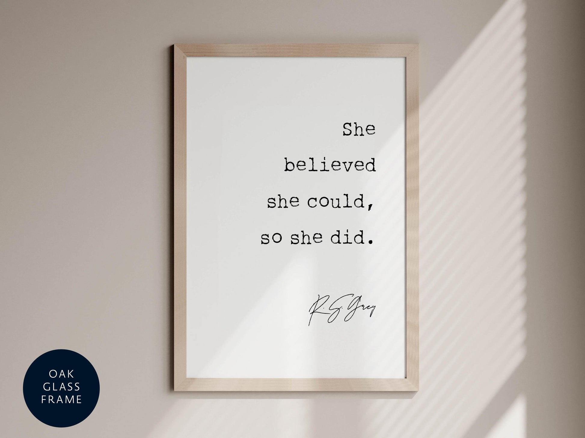 a framed quote by R.S. Grey that reads "She believed she could, so she did."