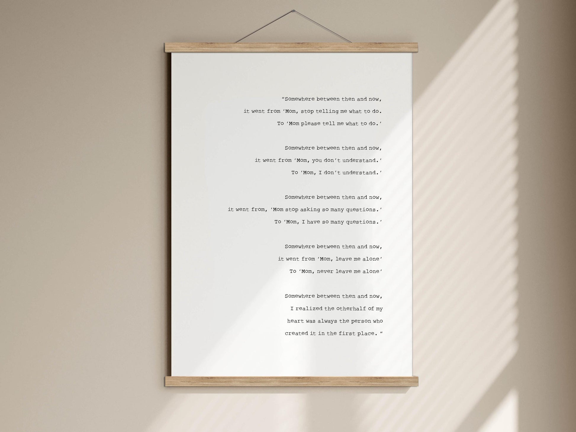 a white poster with a poem displayed on it, hanging on a wall.