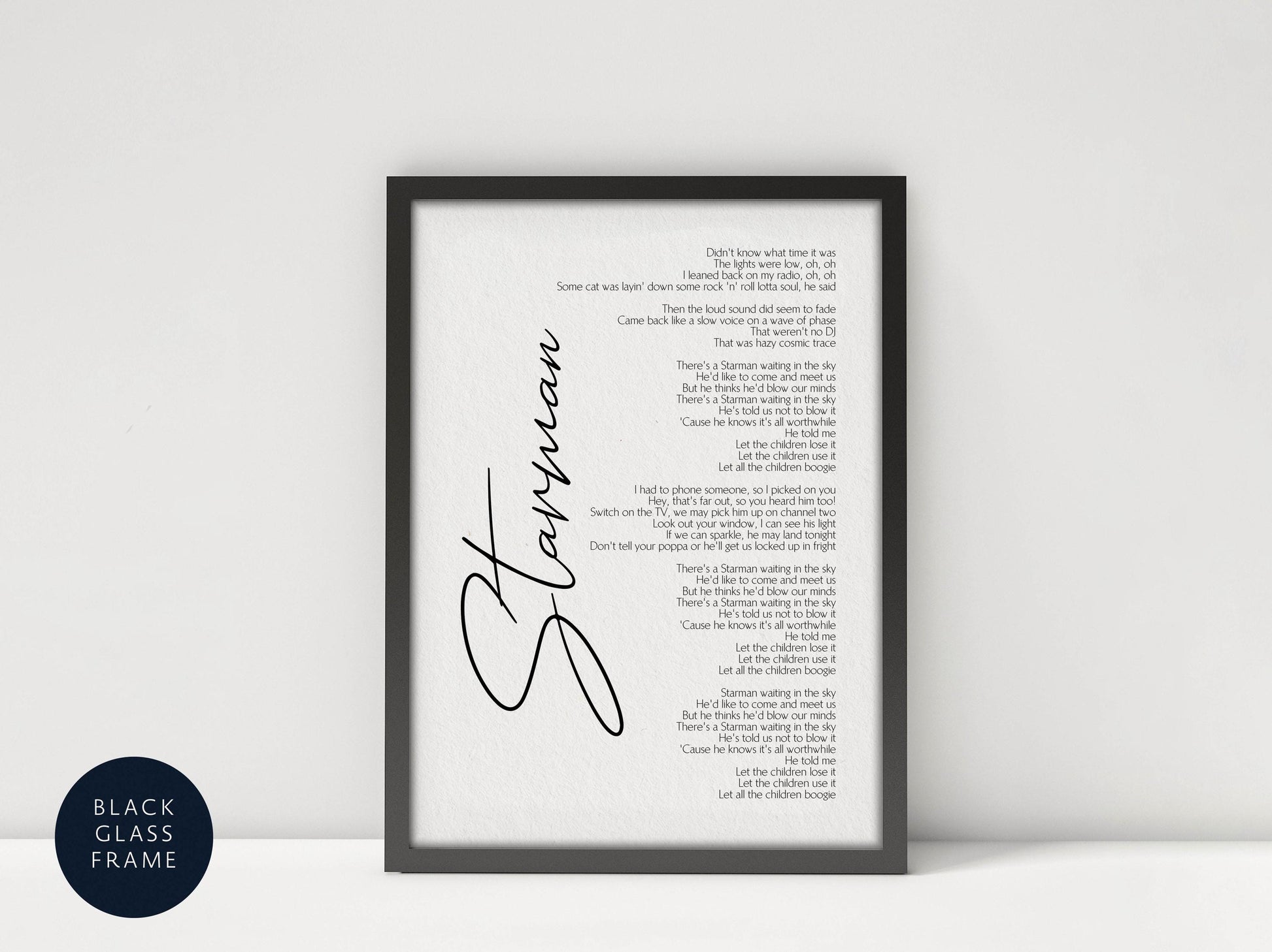 a framed black and white photograph of a framed song lyrics.