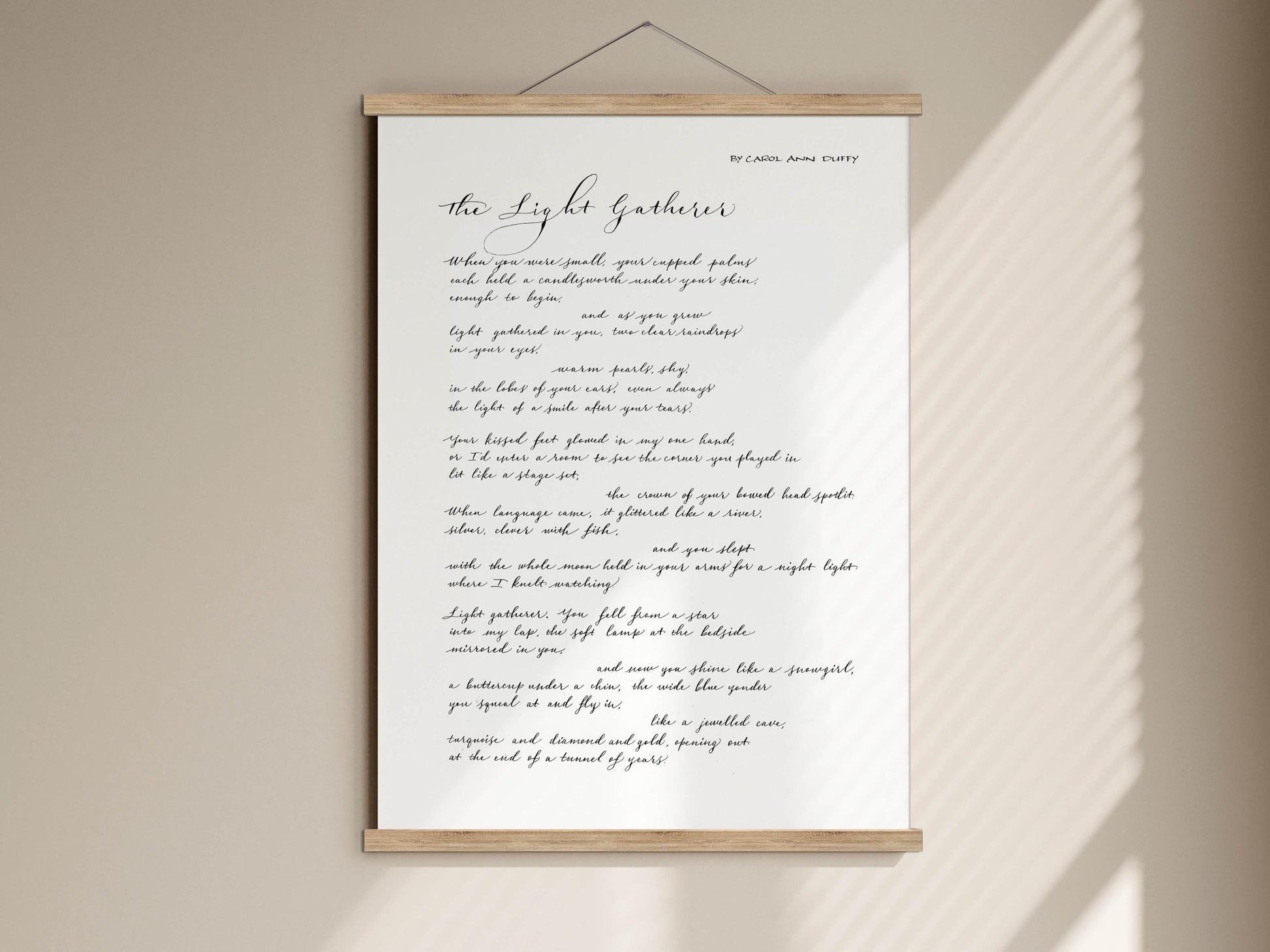 a handwritten poem titled "The Light Gatherings" by Ann Anna Chuyet. The poem is displayed on a wooden frame and is described as a modern art print.