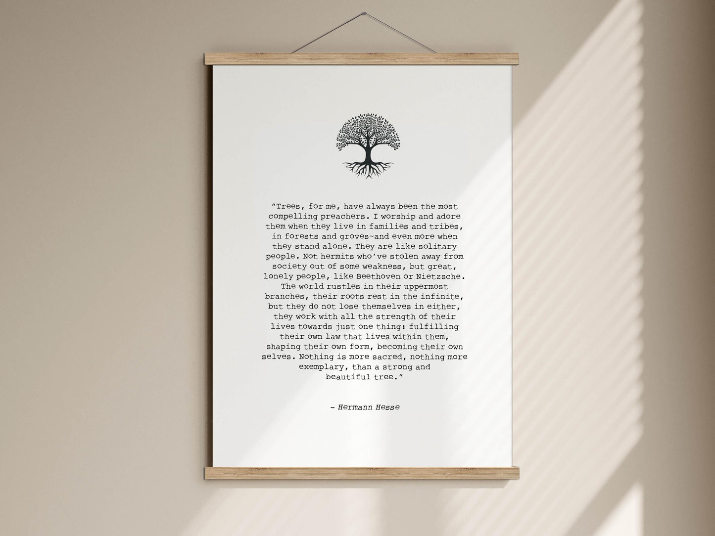 The image is a poster with a quote by Hermann Hesse, which is a piece of literature. The quote is about the importance of trees and their connection to the spiritual world. The poster is framed and mounted on a wall, and the text is written in a serif font.
