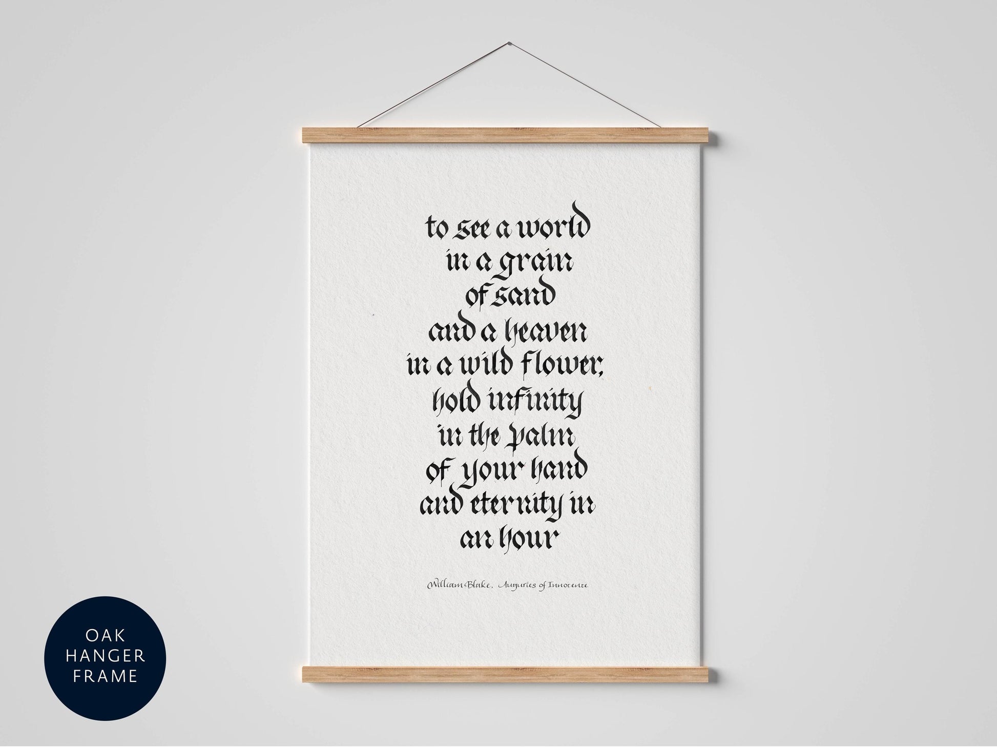 a framed quote in black text on a white background, hanging on a wall.