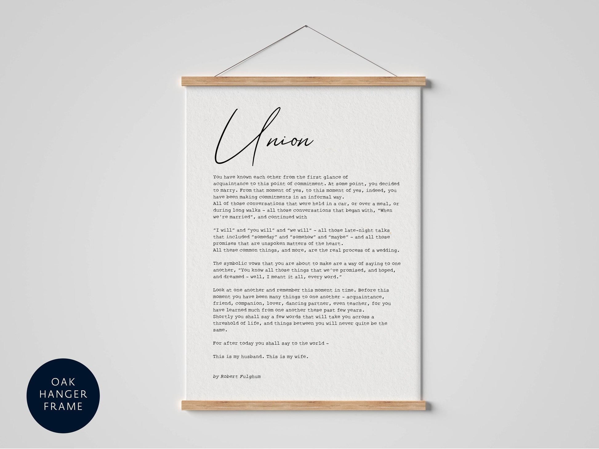 a text document written in black ink on a white background, which is framed and hanging on a wall.