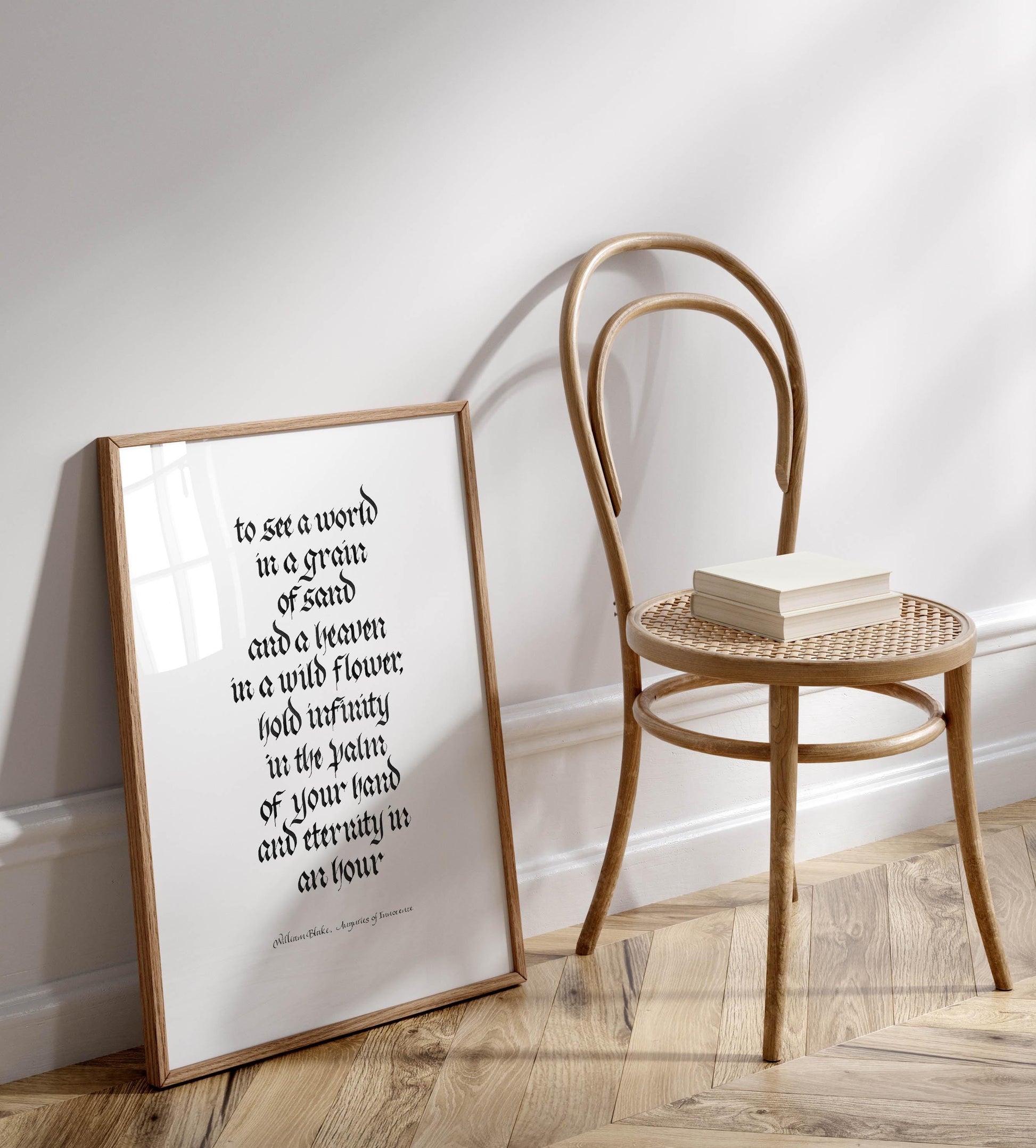 a wooden chair with a book resting on it, positioned next to a framed quote on a wall.