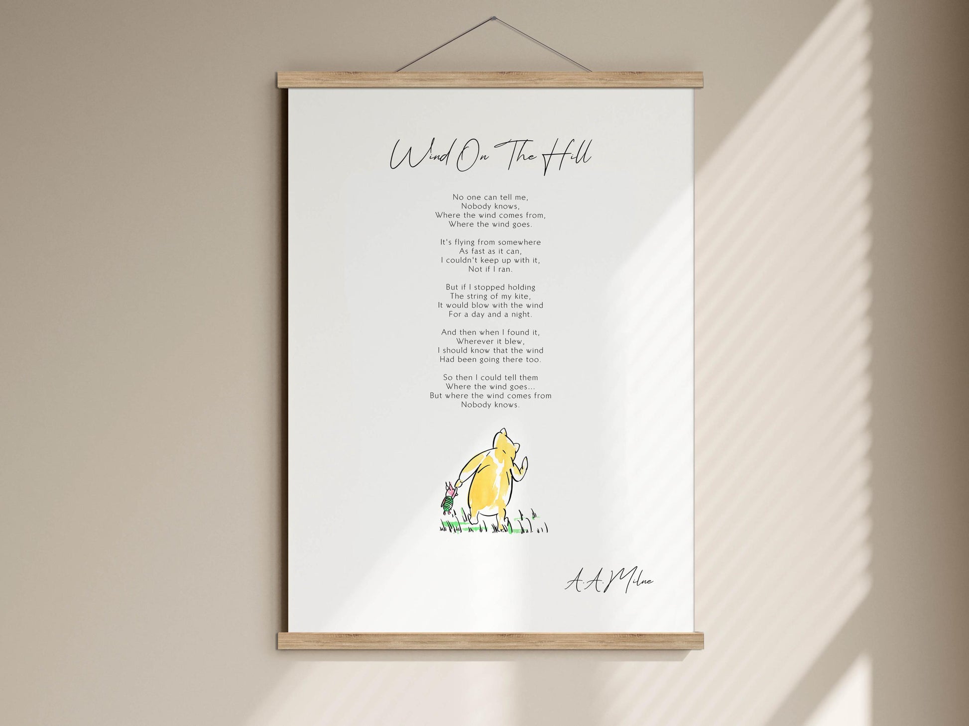 The image is a framed print of a poem titled "Wind on the Hill" by A. A. Milne, featuring a yellow piglet illustration.