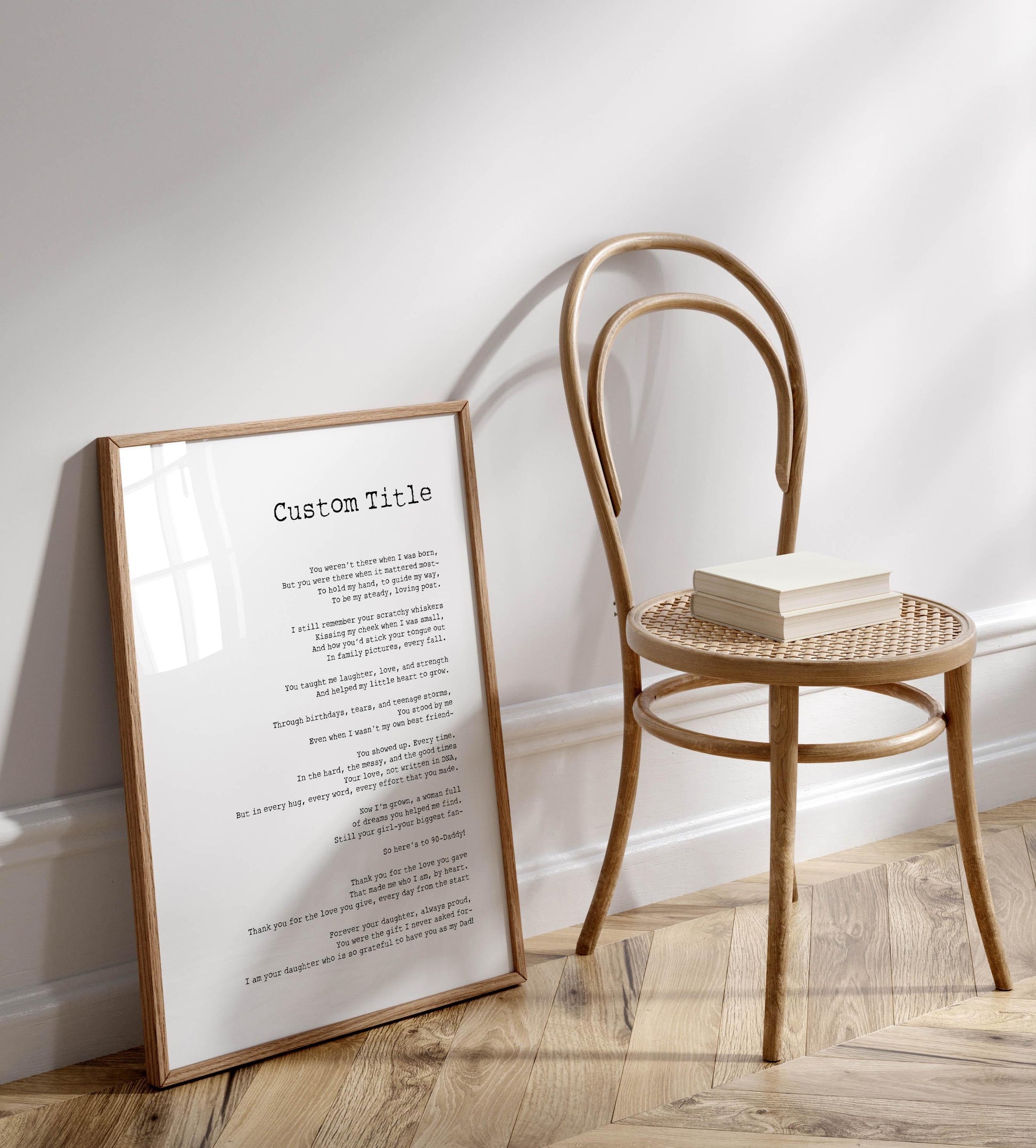 a wooden chair with a white book on it, placed on a wooden floor next to a framed text titled "Custom Title".