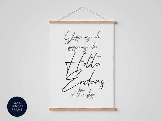 a white poster with black text that reads "Yippee age oh, gippee age oh, Holle Enders in the sky" hanging on a wall.