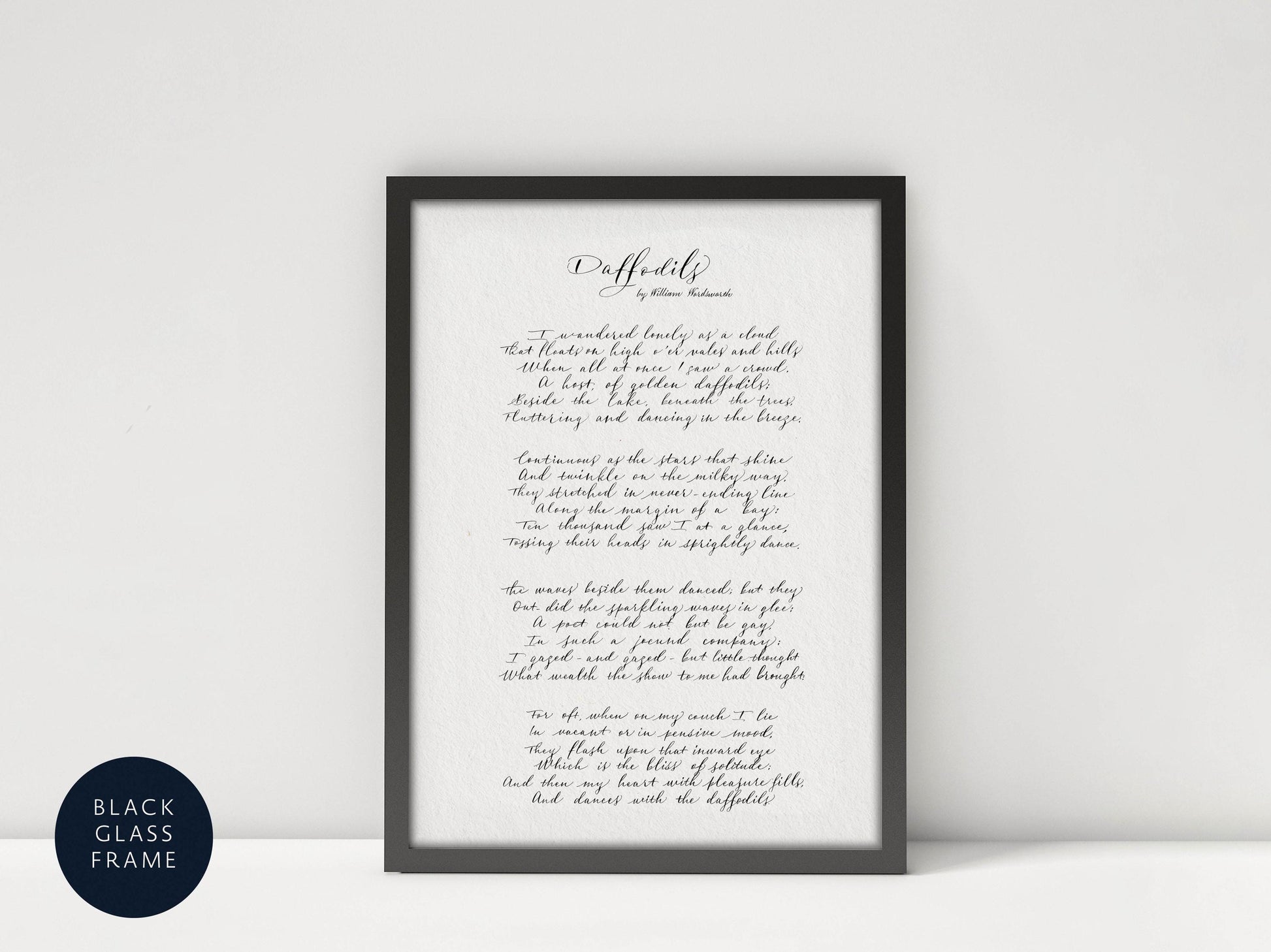 a framed print of a handwritten poem titled "Daffodils" by William Wordsworth, with a black frame and a blue border.