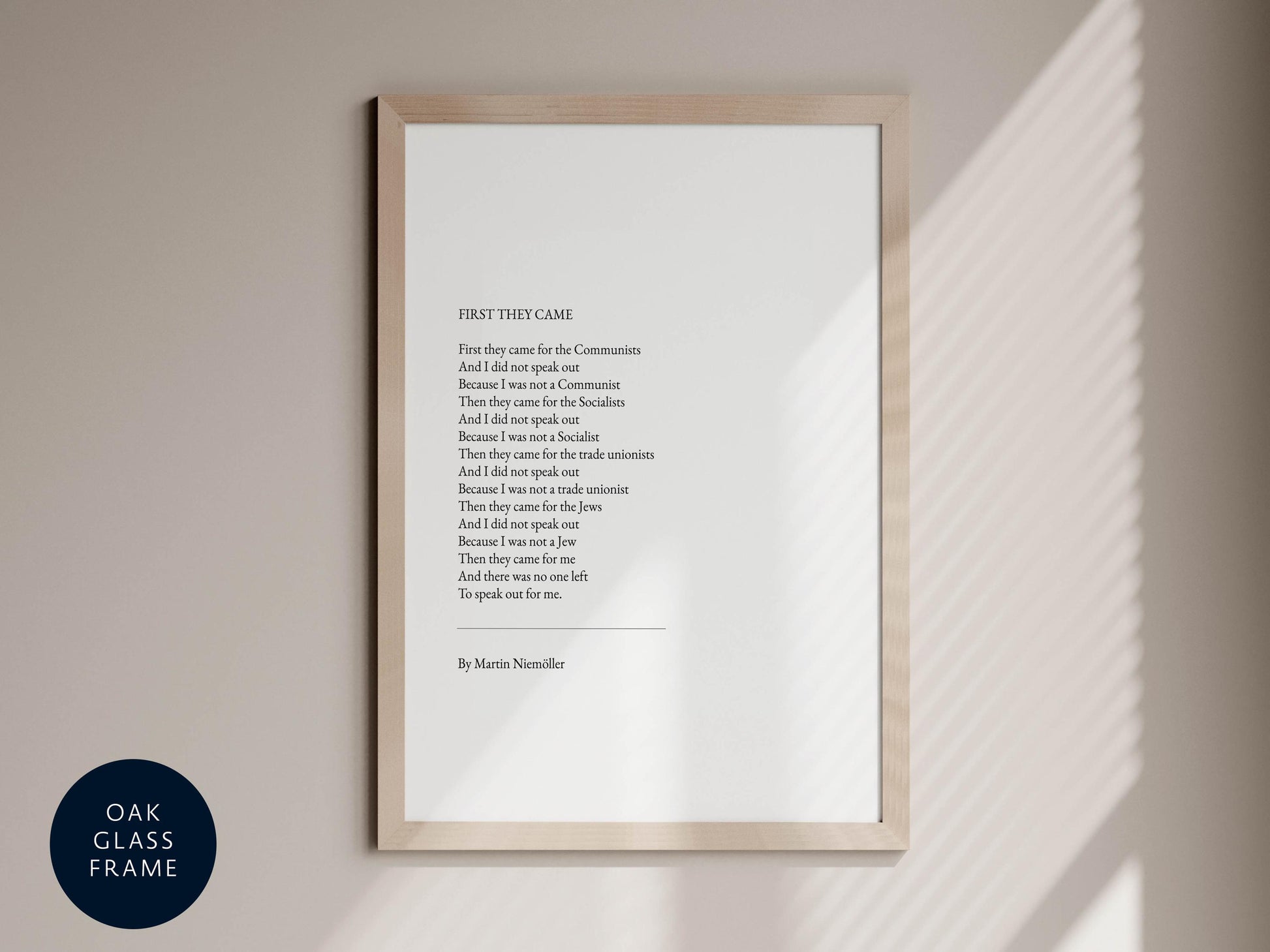 a framed poem titled "First they came for the Communists" by Martin Neillenier, which is displayed on a wall.