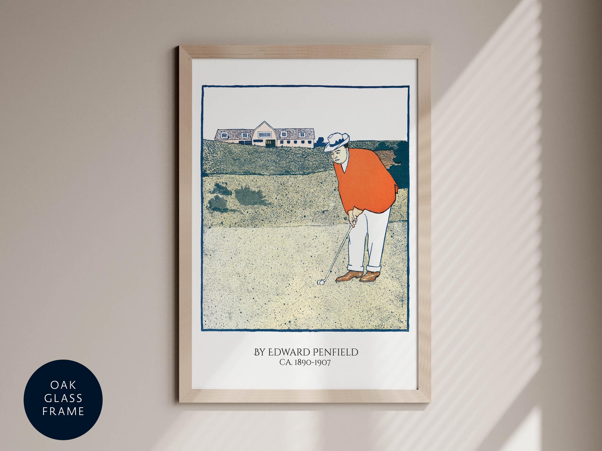 The image is a framed print depicting a golfer in an orange shirt and white pants, holding a golf club and preparing to take a swing.