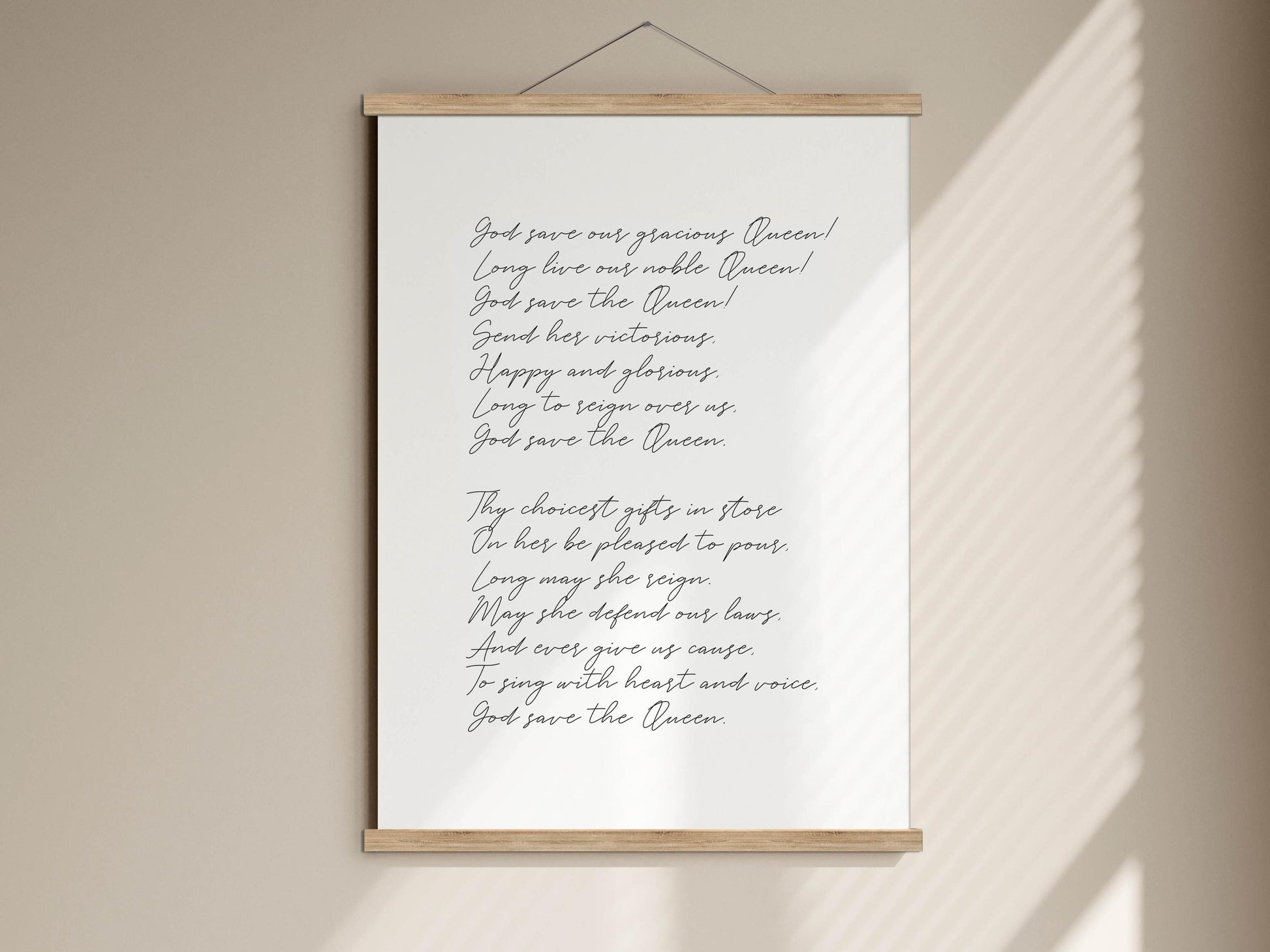 a white poster with a poem written in black cursive text, hanging on a wall.