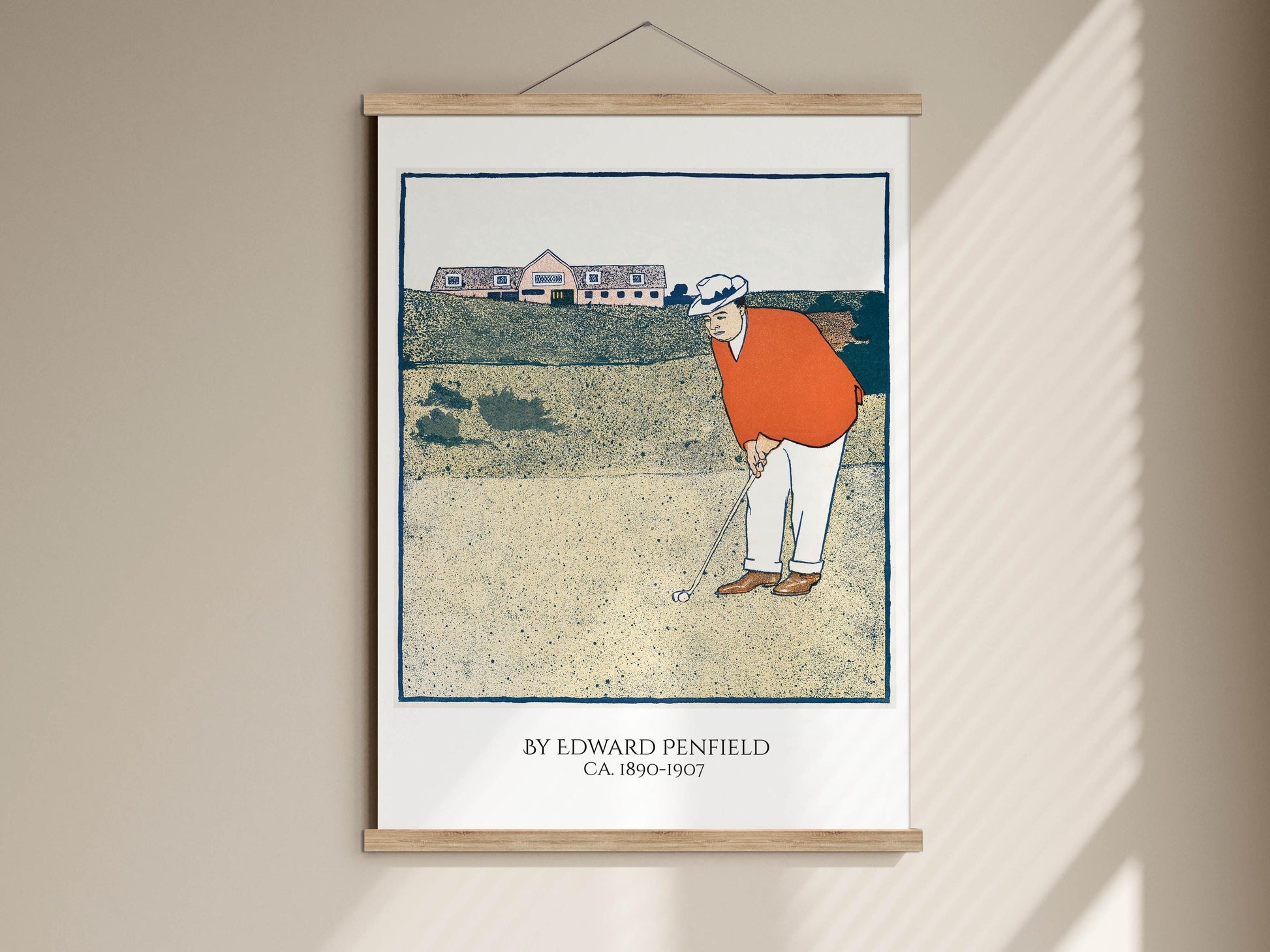 The image is a framed print depicting a golfer in an orange shirt and white pants, holding a golf club and preparing to take a swing on a golf course.