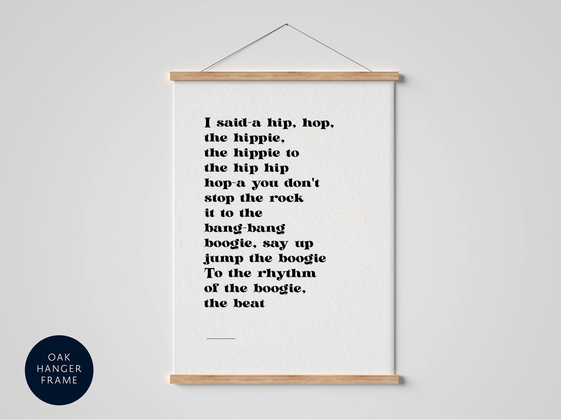 a white poster with black text that reads: "I said a hip, hop, the hippie to the hip hip hop, you don't stop the rock it to the bang-bang boogie, say up jump the boogie To the rhythm of the boogie, the beat"