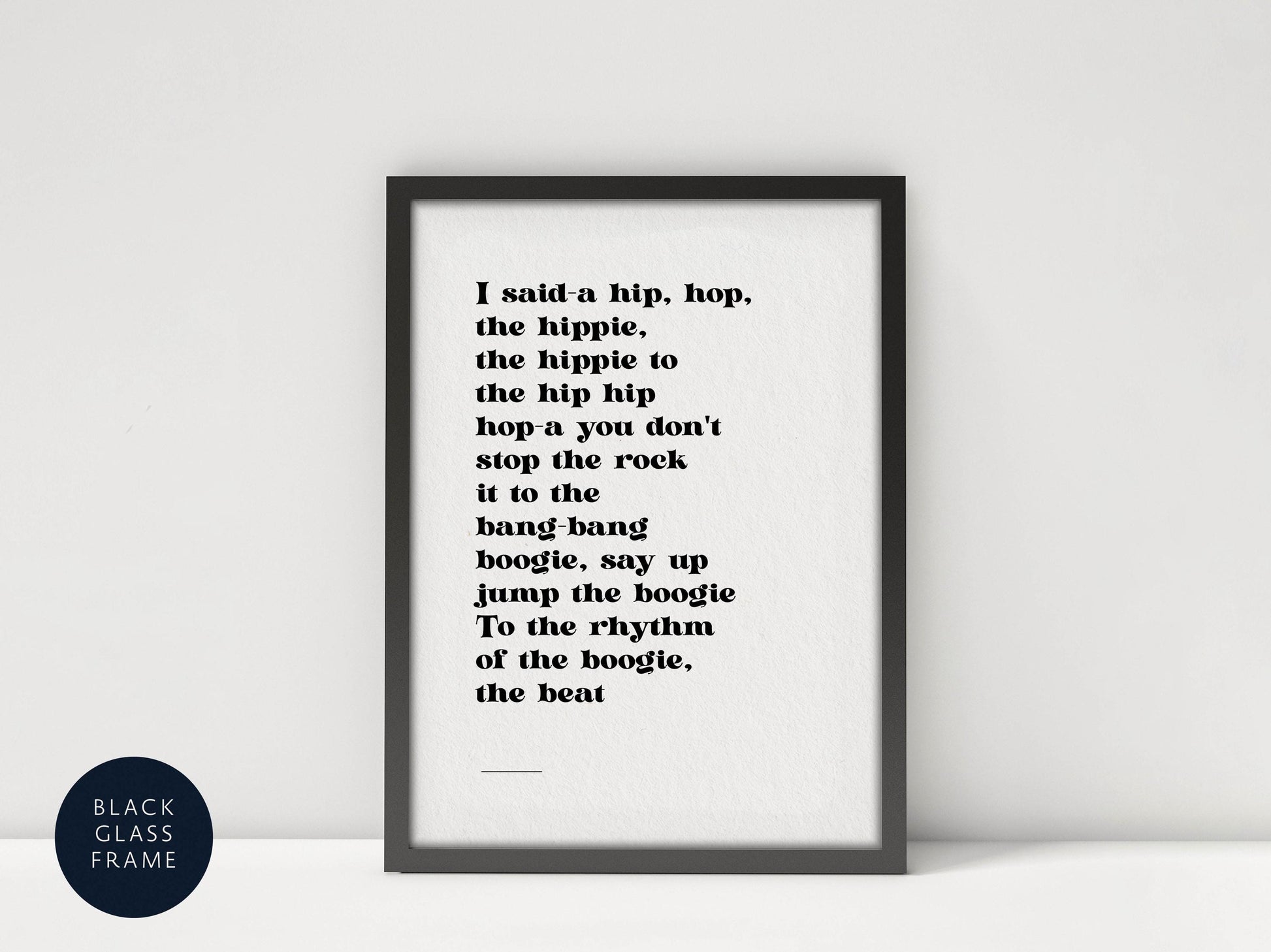 a framed quote with a black and white color scheme, placed on a white surface.