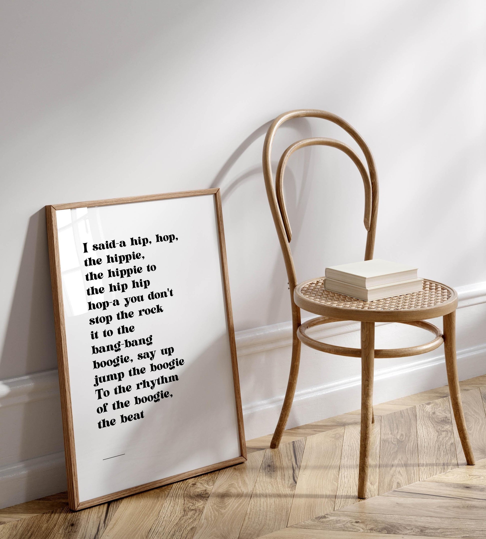a wooden chair with a framed quote on the wall next to it.