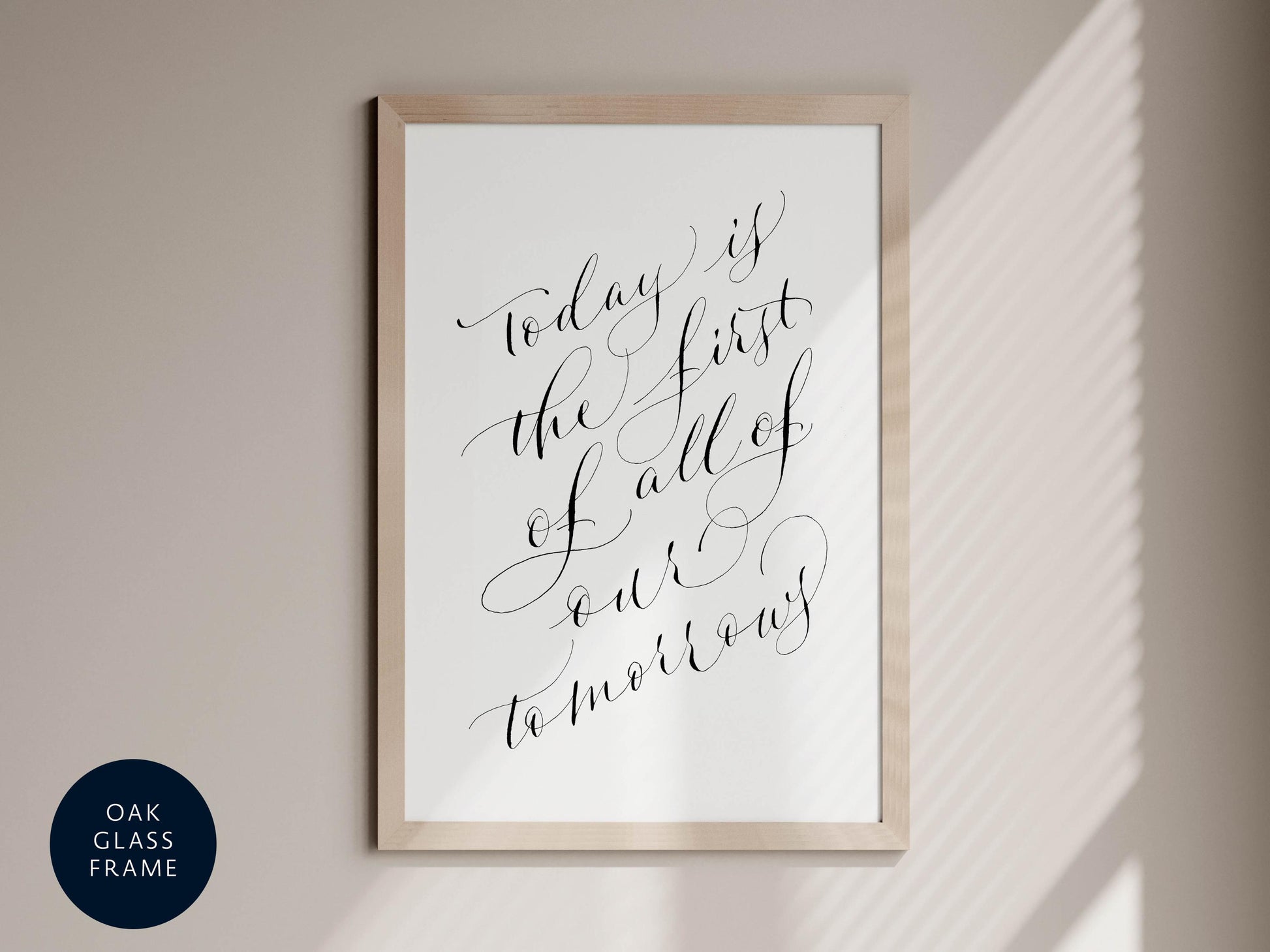 a framed print with the text "Today is the first of all of tomorrow" written in an elegant cursive font.
