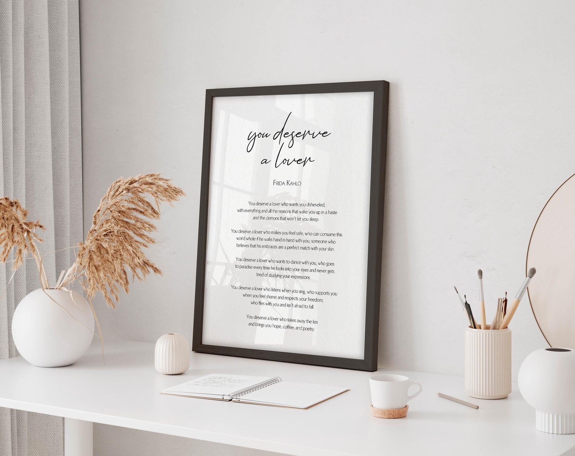 a framed poem titled "You Deserve a Lawyer" displayed on a white shelf, with a notebook, coffee cup, and decorative items such as a vase and a plant nearby.