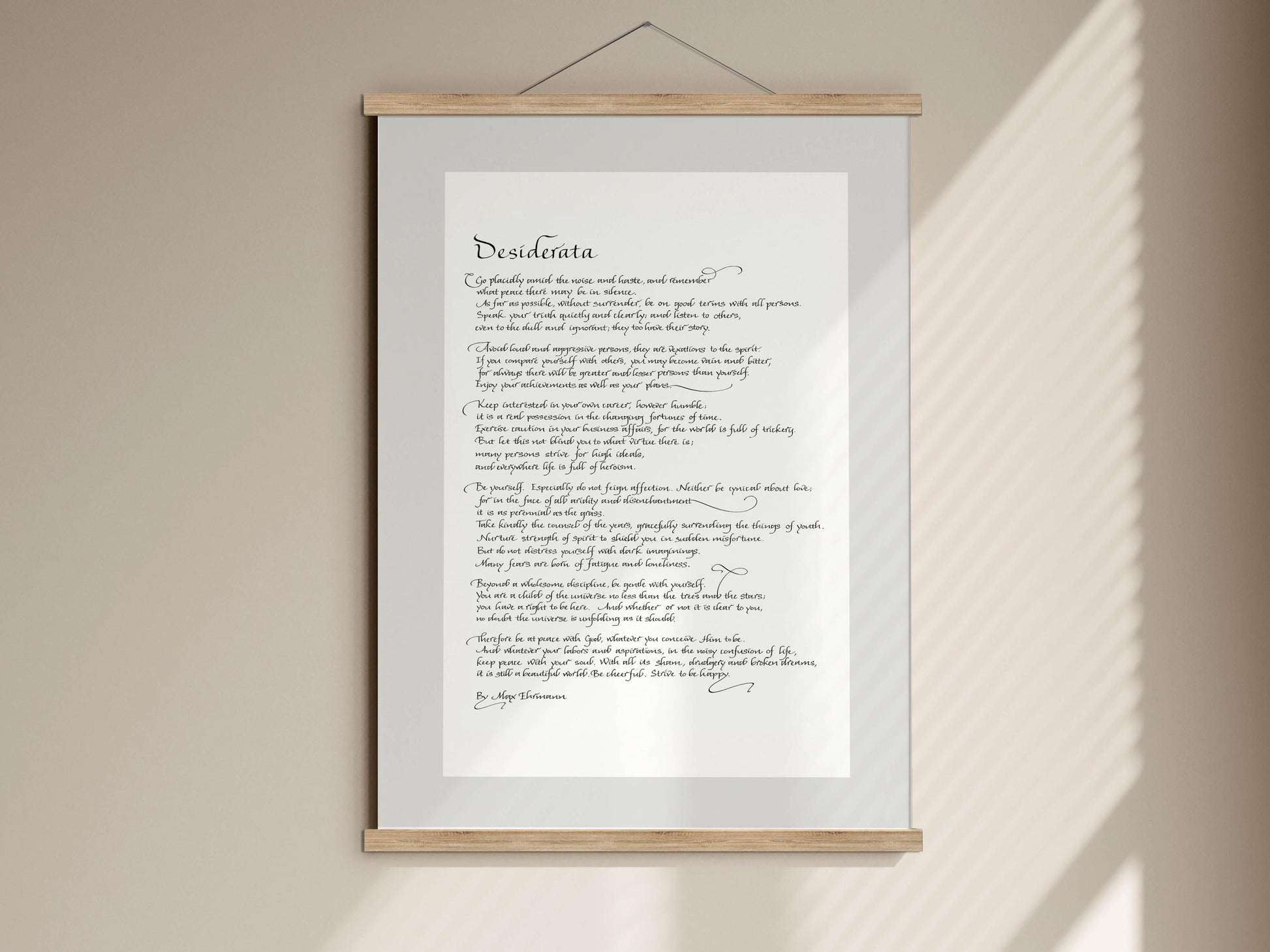 The image is a framed print of a poem titled "Desiderata" by Ogilvie. The poem is written in a cursive font and is displayed on a white background.