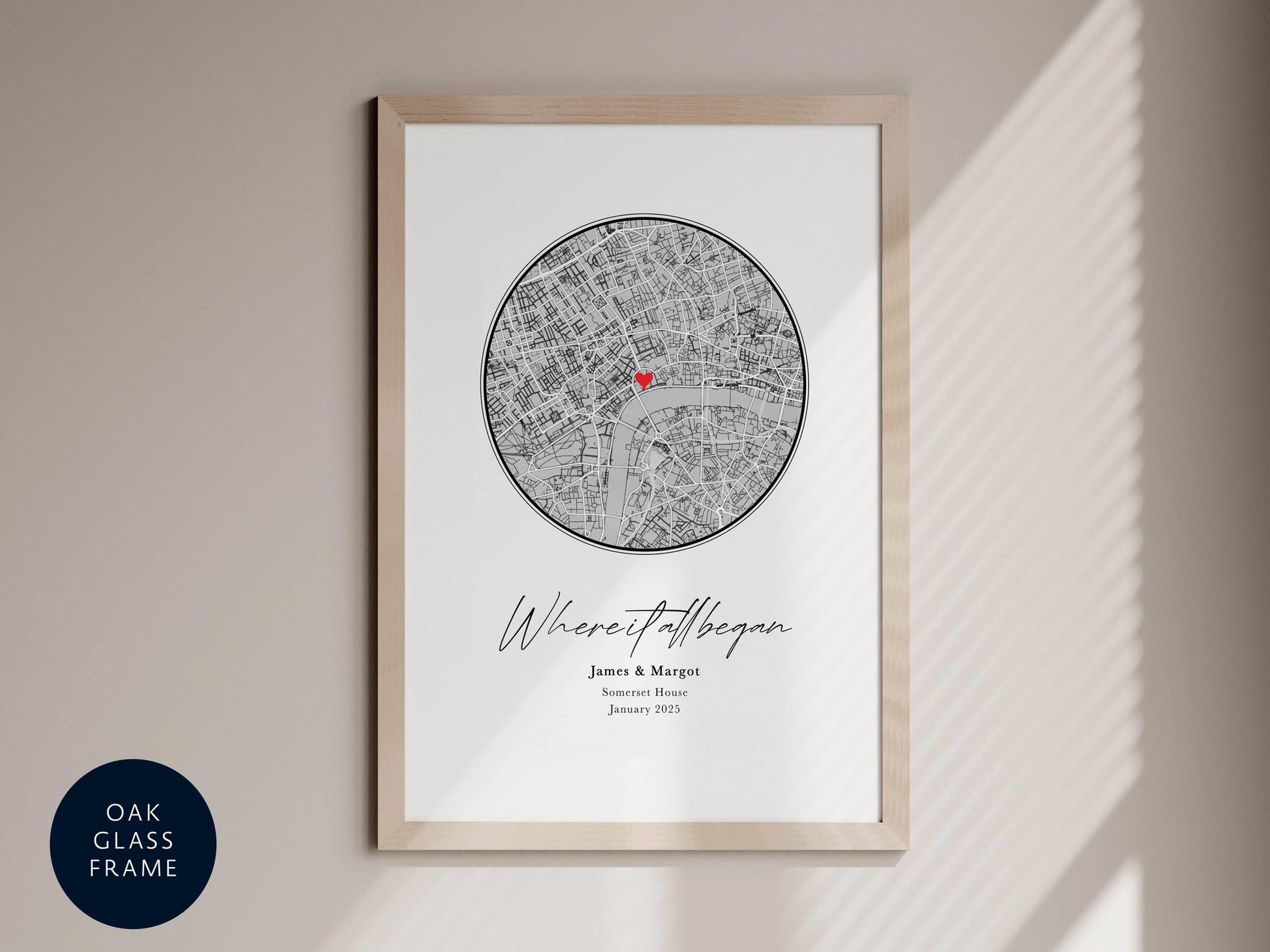 The image is a framed print featuring a map of London with a red heart symbol in the center. The text below the map reads "Where it began" and includes the names "James & Marga" and "Sonia Marga" as well as the dates "January 2005".