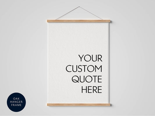 A white poster with the text "YOUR CUSTOM QUOTE HERE" written in black on it, hanging on a wall.