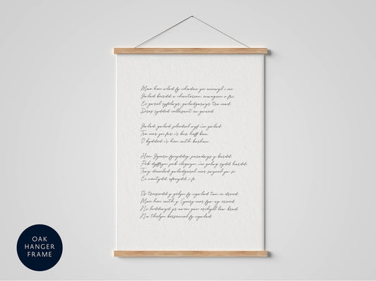 a white framed poster with handwritten text, hanging on a wall.