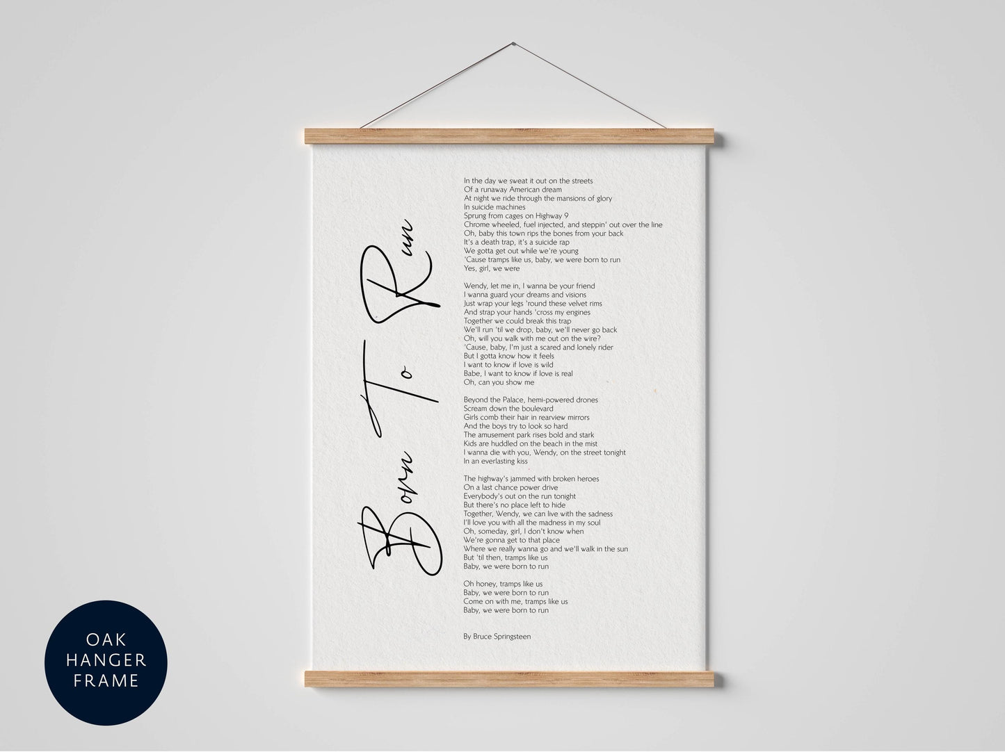 The image is a framed print of a poem titled &quot;Born to Run&quot; by Bruce Springsteen, which is hung on a wall.