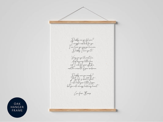 a white poster with black cursive text, hanging on a wall.