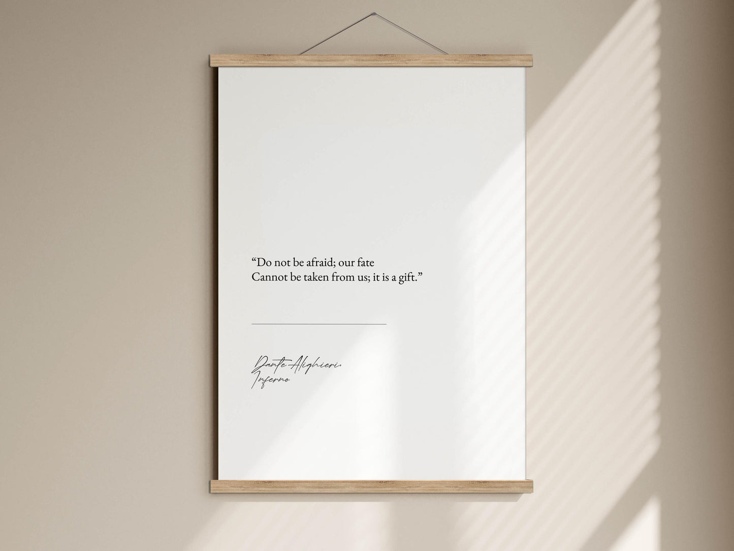 a quote on a white poster hanging on a wall, with a shadow cast on the wall below.