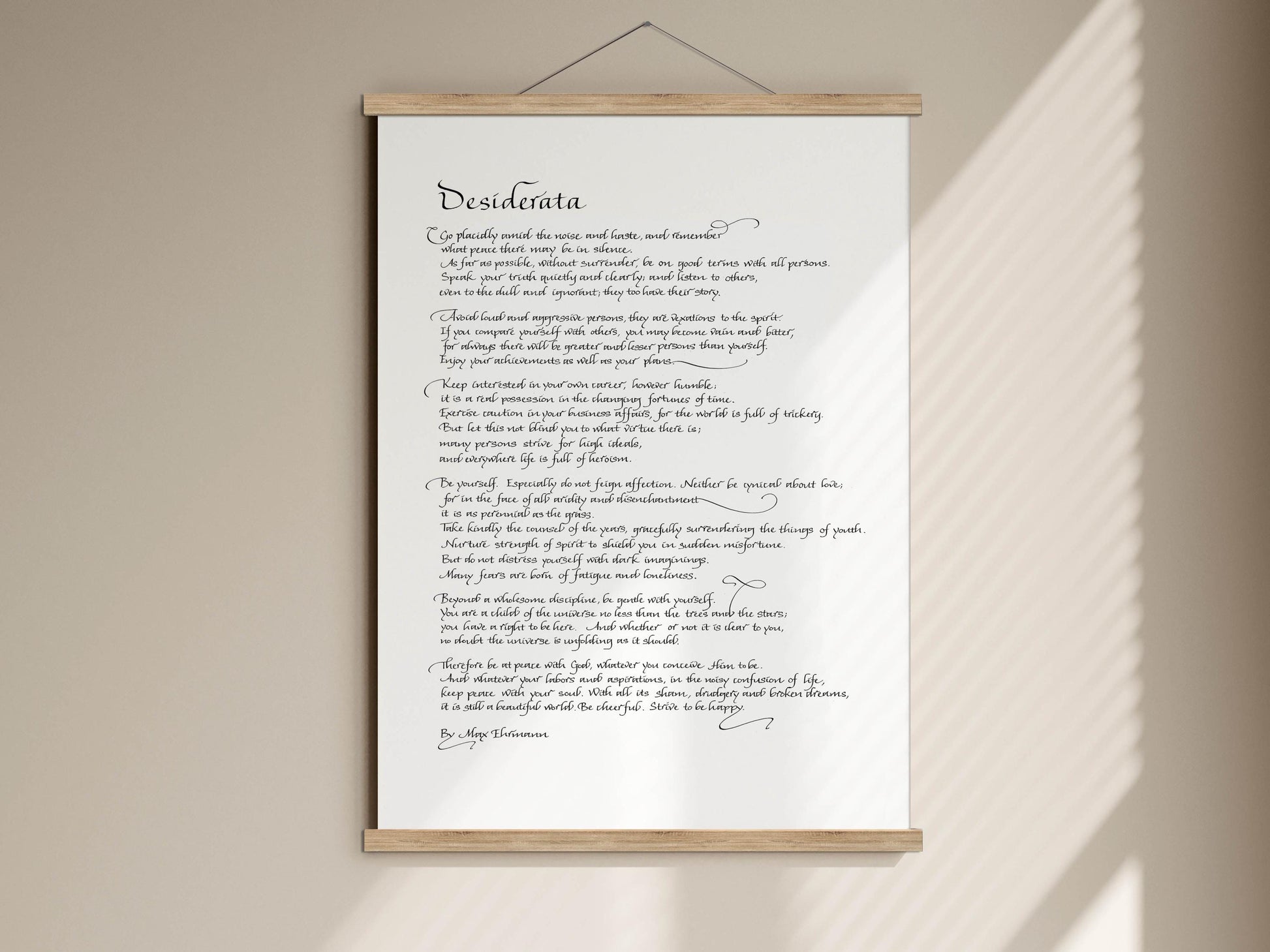 a handwritten poem on a white scroll, which is mounted on a wall.