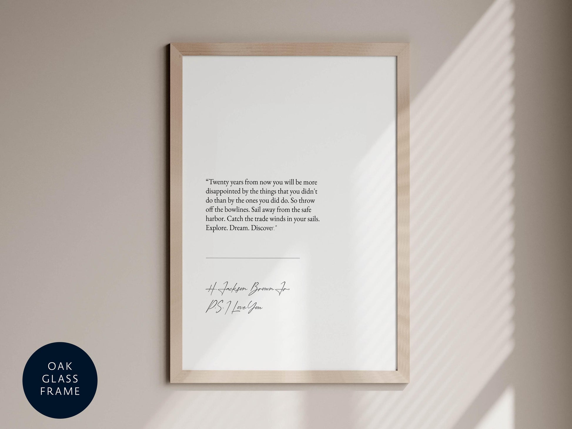 a framed quote on a wall next to a window