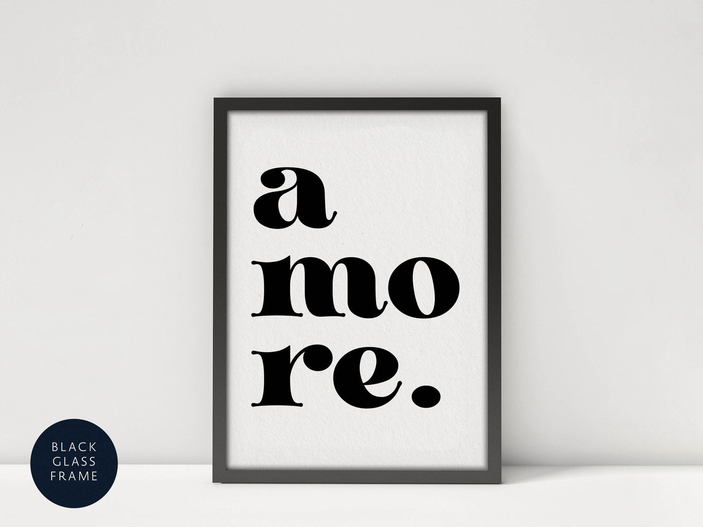 A framed poster with the text &quot;a more.&quot; in a bold, sans-serif font.