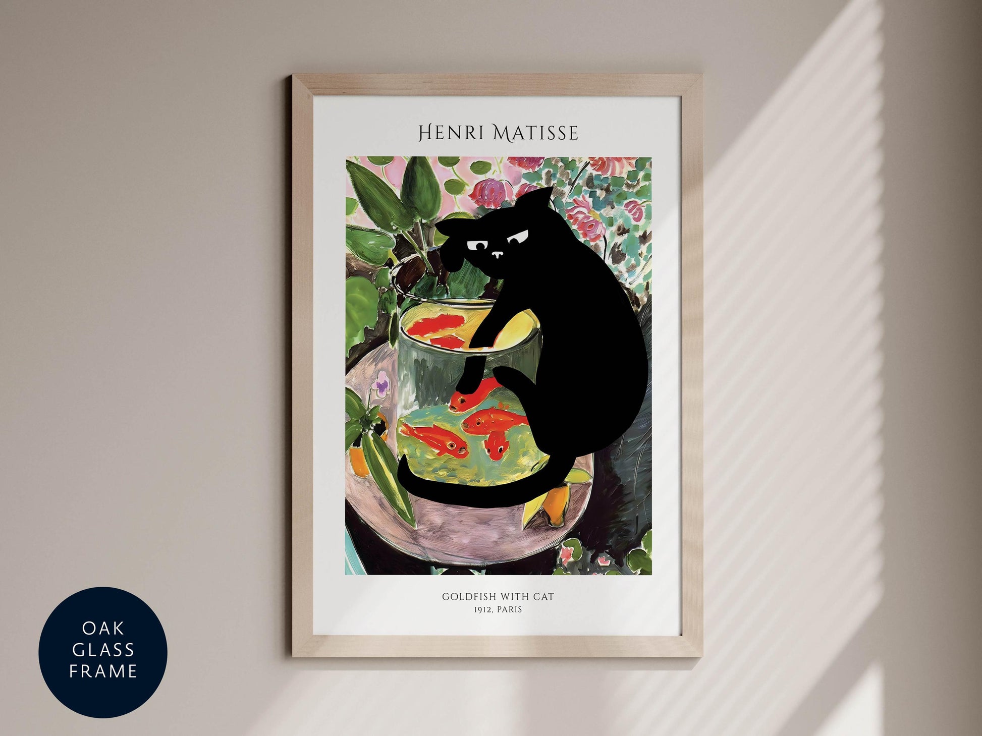 The image is a framed print of the famous painting &quot;Goldfish with Cat&quot; by Henri Matisse, which depicts a black cat sitting in a glass bowl filled with fish.