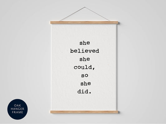 A white poster with black text that reads &quot;she believed she could, so she did.&quot;