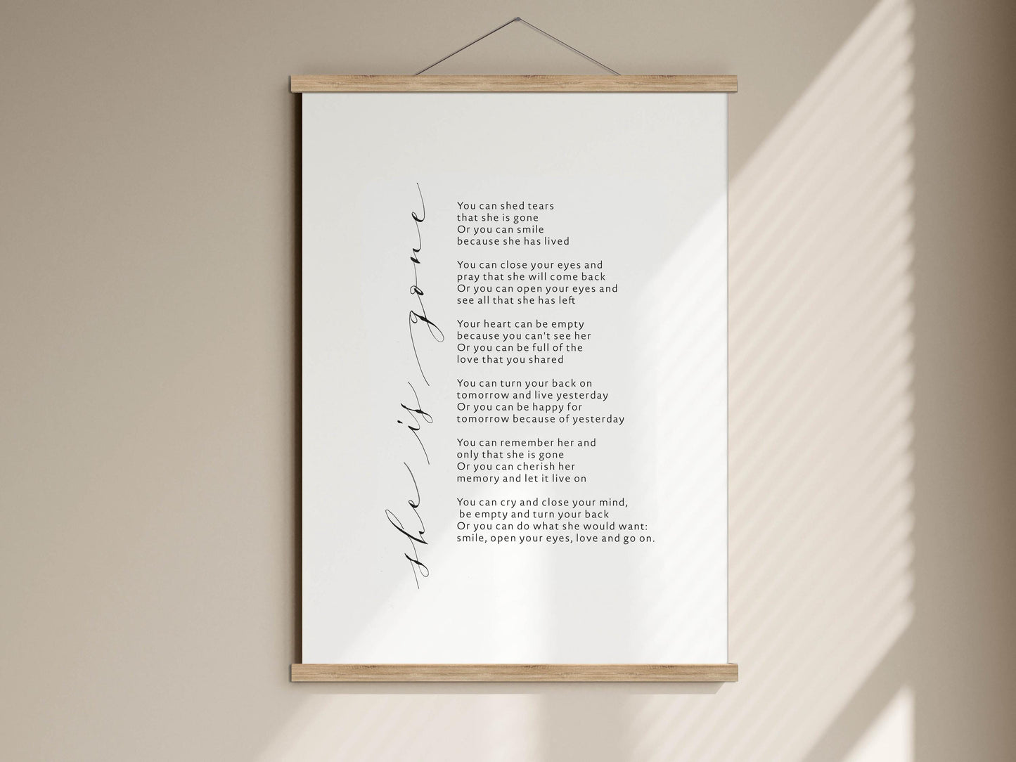 The image is a poster with a poem written in cursive. The poem is about love and memories, and it includes a list of lines that describe the beauty of love and the importance of memories. The poster is hanging on a wall, and the text is written in a cursive font.
