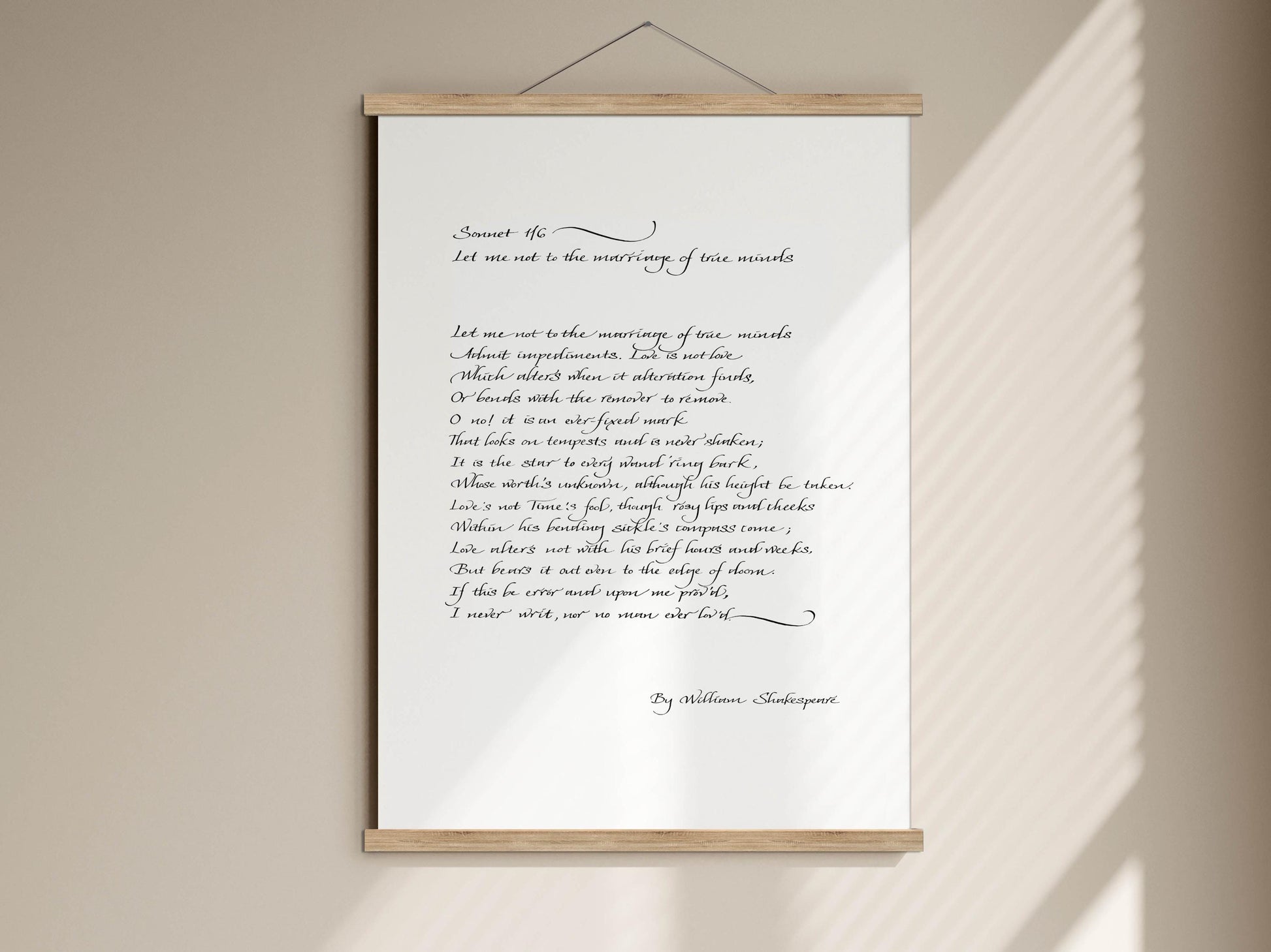 a handwritten poem on a white paper scroll, which is mounted on a wall. The poem is titled &quot;Let me not to the marriage of true minds&quot; and is written in cursive. The text is not too long, and it focuses on the marriage of true minds.