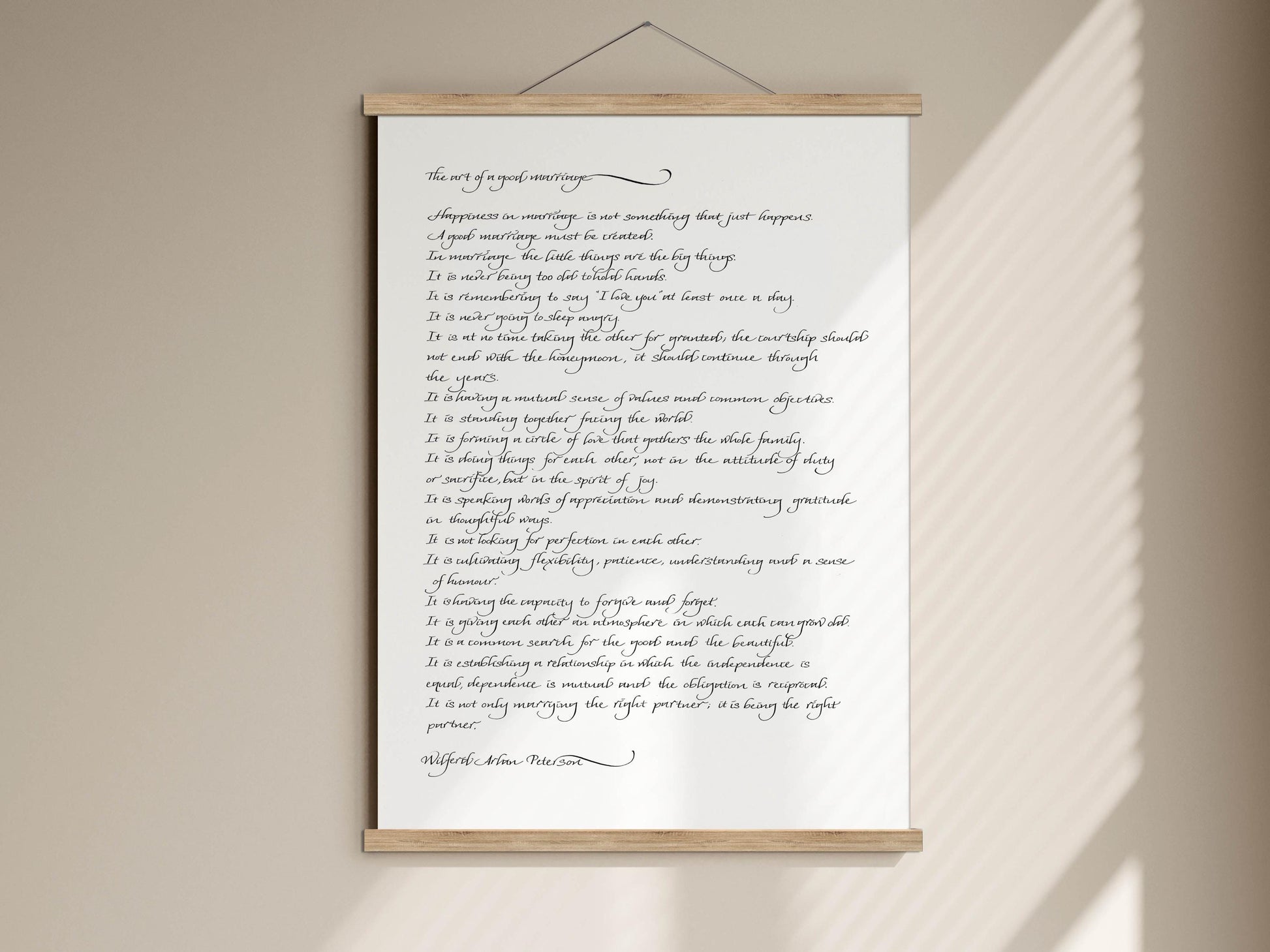 The image is a handwritten text on a white background, which appears to be a quote or a poem. The text is written in cursive and is framed by a wooden border.