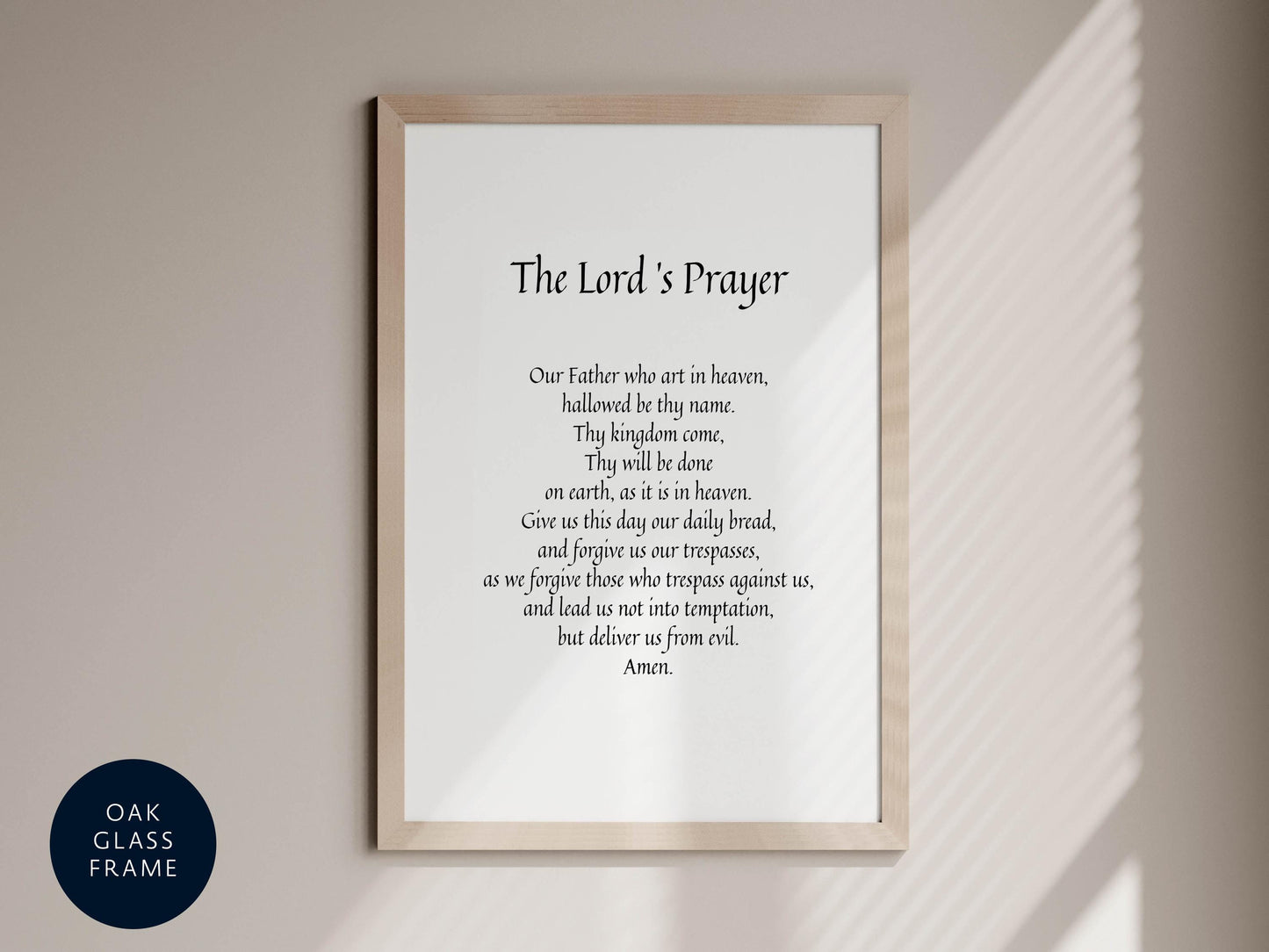 a framed prayer poster with the Lord&#39;s Prayer written on it, hanging on a wall.