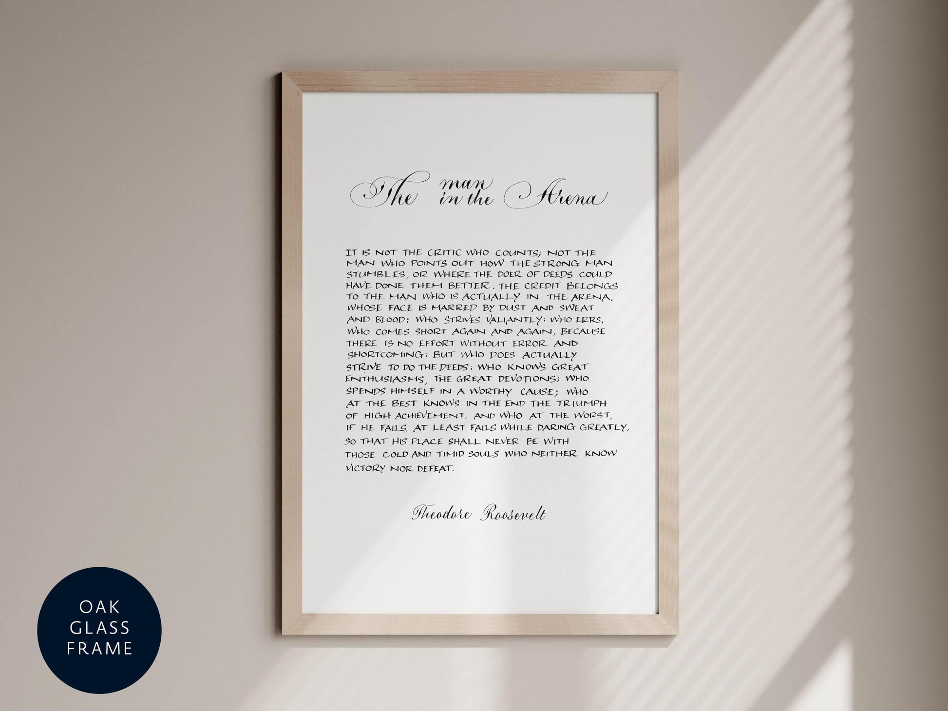 a framed text that reads &quot;The man in the arena&quot; in a cursive font.