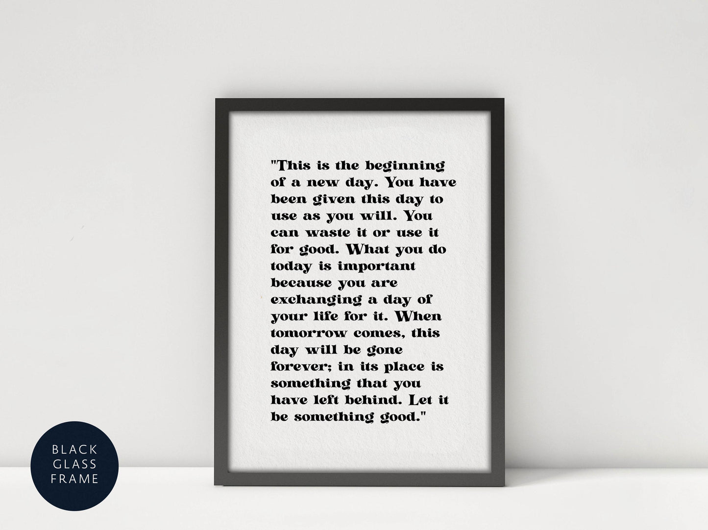 a quote in black text on a black background, framed in a black frame.
